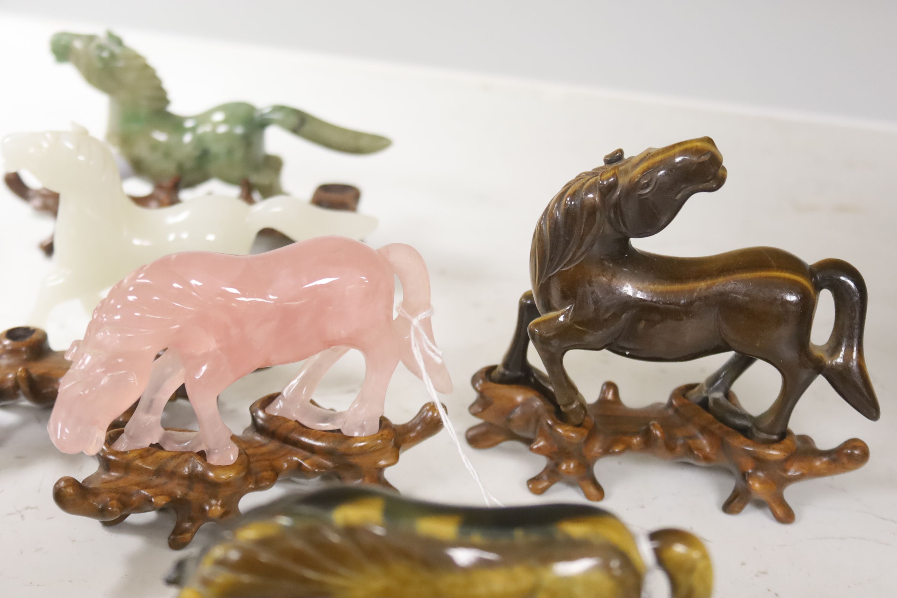 Eight Chinese 20th century carved hardstone 'Horses of Mu Wang'